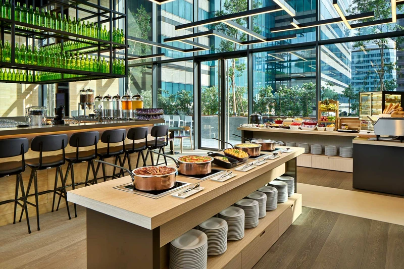 Restaurant with buffet island, industrial shelving and terrace views