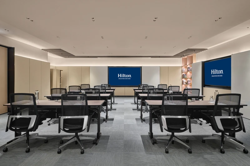 Hilton Singapore Orchard Level 5 Tembusu in classroom setup with modern hotel meeting room seating and integrated presentation screens