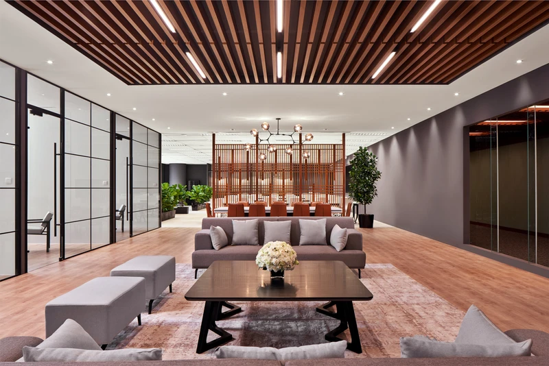 Lounge with biophilic plants, timber screen and vintage rug