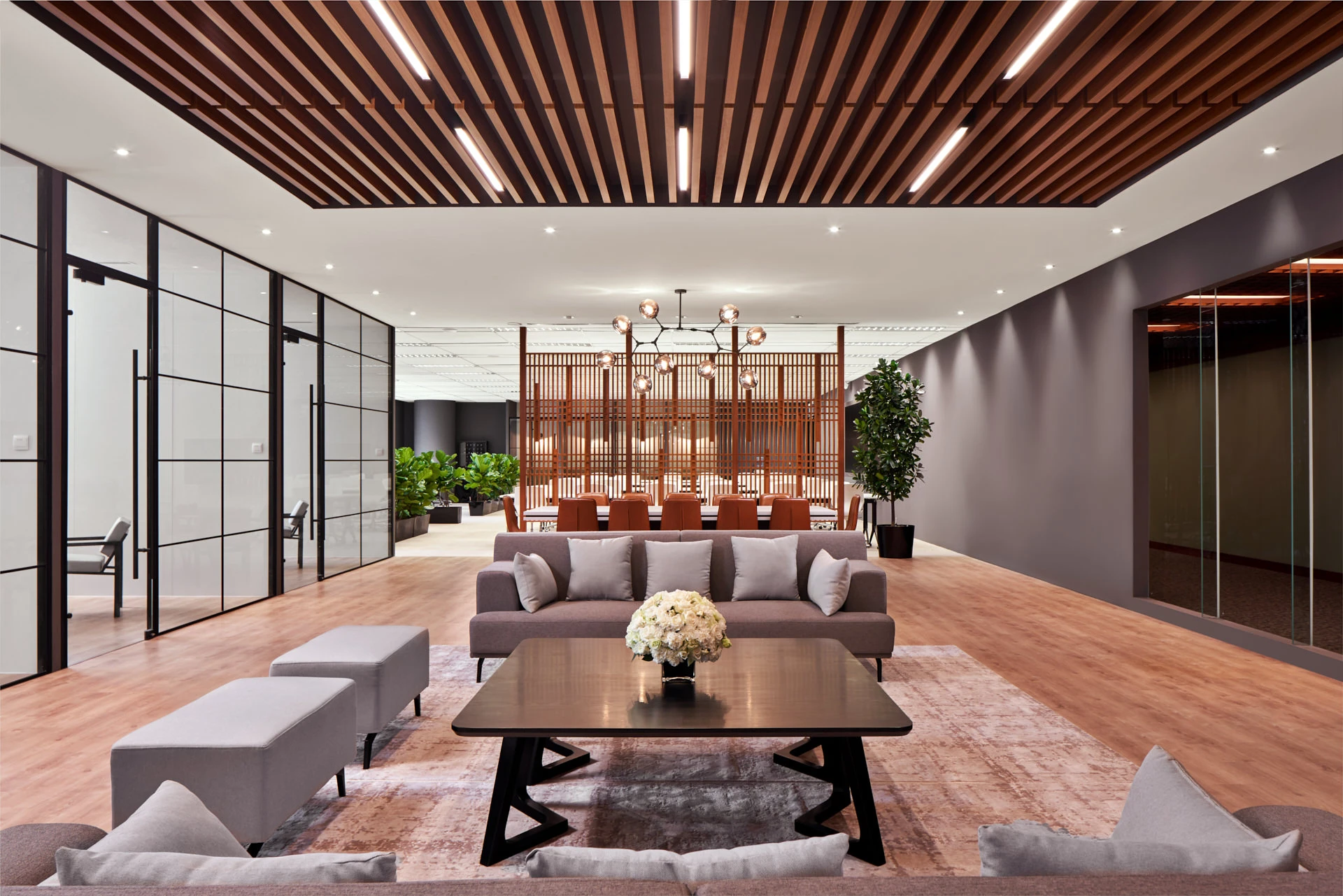 Lounge with biophilic plants, timber screen and vintage rug