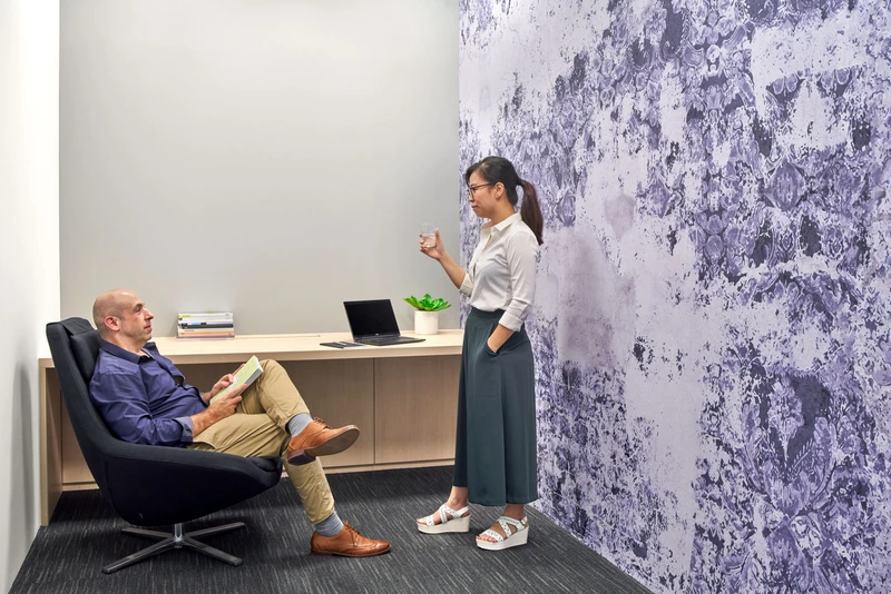 Breakout nook with purple floral feature wall and floating timber ledge