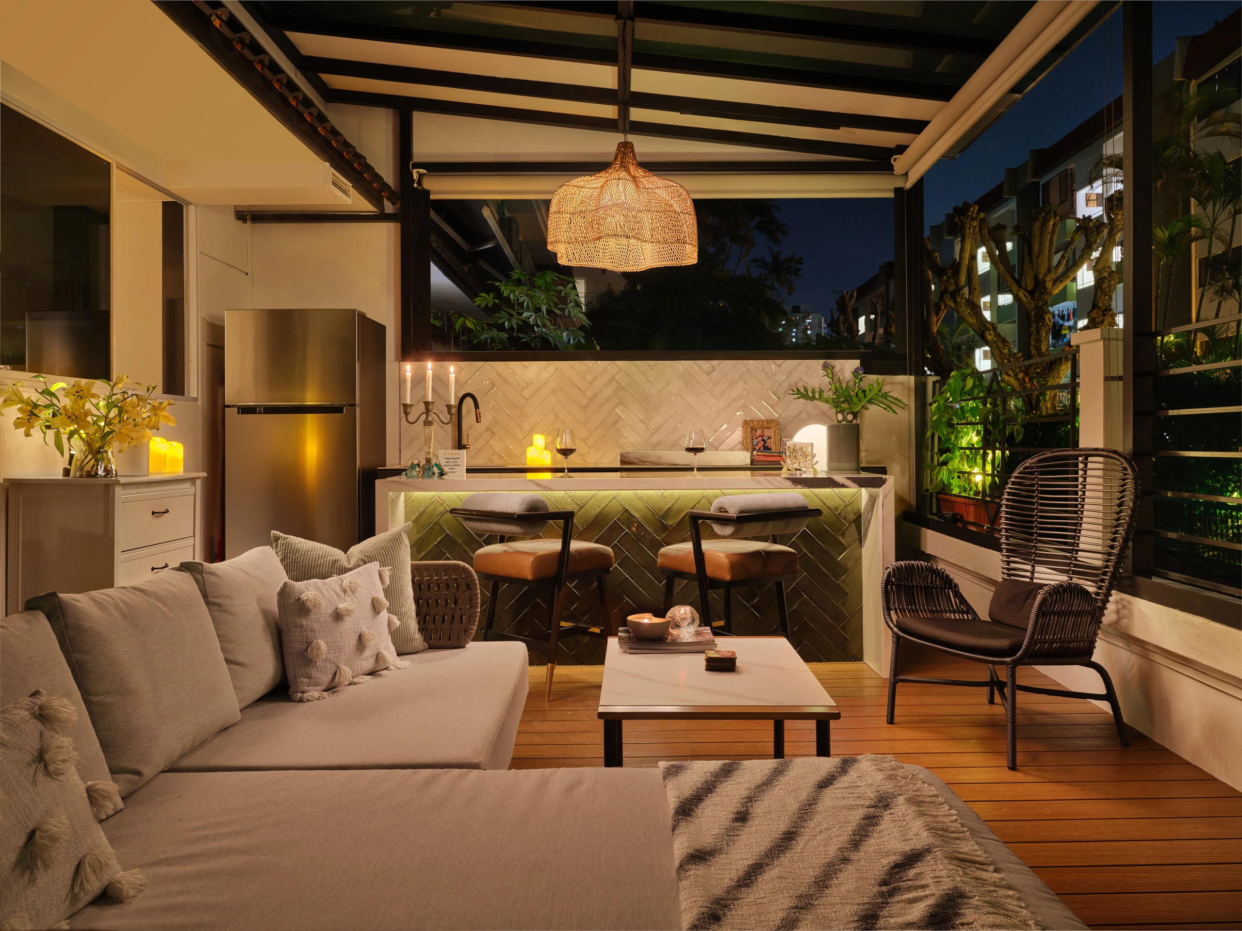 Outdoor bar area with woven textures and seating at dusk