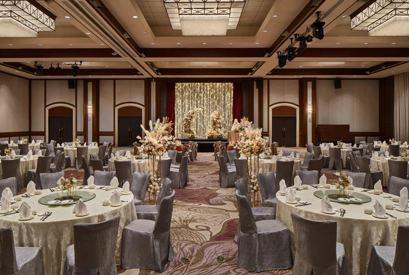 Paradox Singapore bohemian wedding setup with pampas grass, cream blooms, and fairy-light stage
