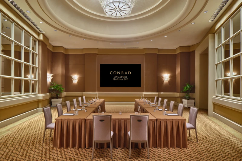 Conrad Singapore Marina Bay Grand Salon in U-shape setup with curved ceiling detail, warm wall panels and banquet seating
