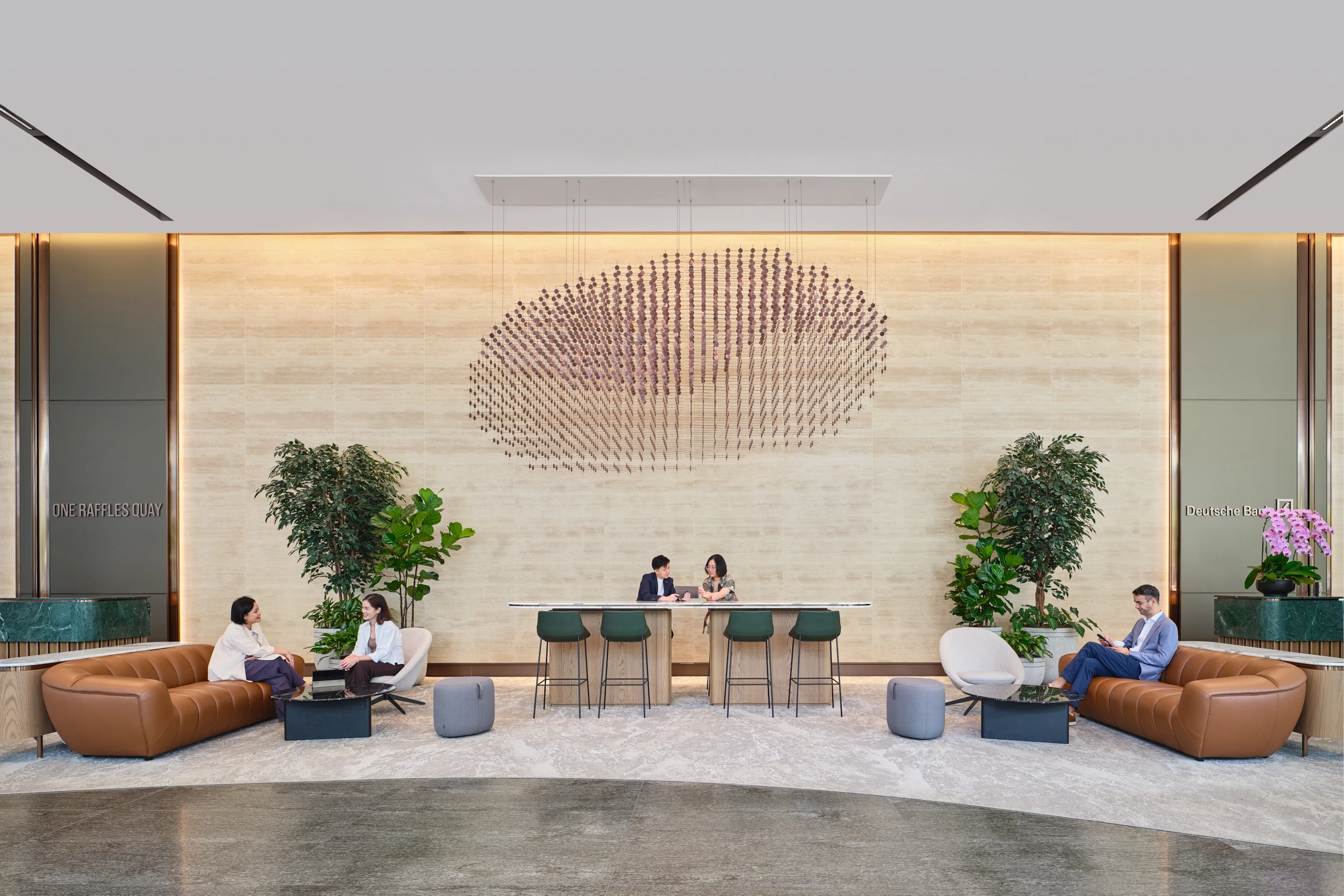 One Raffles Quay South Tower reception seating area with circular wall feature